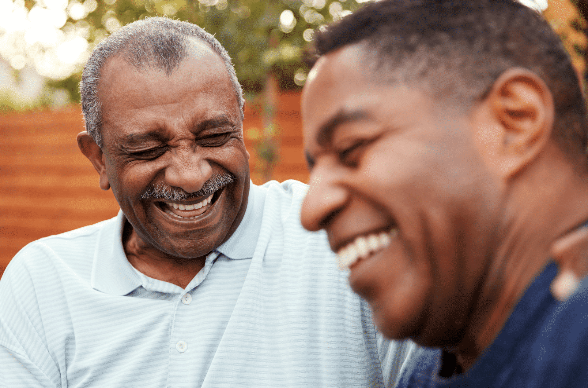 Отец был путешественником. Black Senior. Son laughing. Father and son laughing.